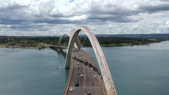Aerial view of traffic on JK Bridge (Portuguese: Ponte JK ), a steel and concrete arch bridge across Lake Paranoa in Brasilia, Federal District, capital of Brazil.