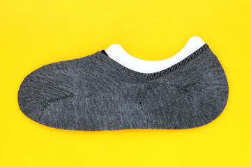 Gray socks on yellow background.