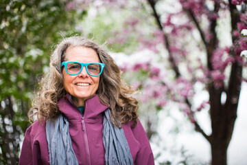 A portrait of a woman wearing a fun pair of glasses outside in nature on a beautiful day in Colorado, USA