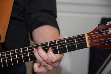Fototapeta na wymiar A man plays the guitar, detail