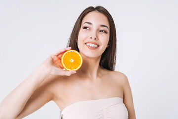 Obraz na płótnie Canvas Beauty funny portrait of happy smiling asian woman with dark long hair with oranges in hands on white background isolated