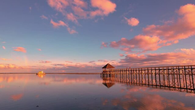 Fiji aerial footage of tropical paradise warm sunset over beach pier - Maui Bay