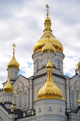 Religious buildings. Pochayiv, Ukraine, 2021, may - orthodox church with golden domes, Trinity cathedral and bell tower in Pochaev Lavra