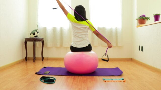 A woman stretching with an exercise garter