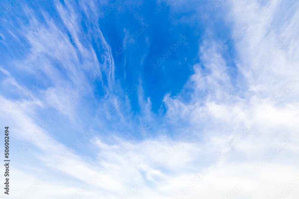Wall mural a vast blue sky with freedom shape of slanting clouds floating overhead. soft and pure cloudy in sun