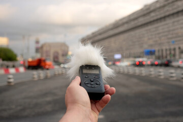 Voice recorder in hand.