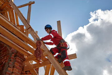 A specialist is repairing the roof. Rope access