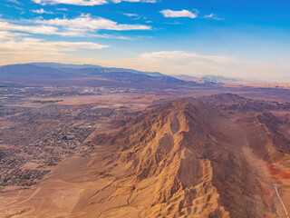Fototapeta na wymiar Sunset aerial view of the Frenchman Mountain and cityscape of Las Vegas
