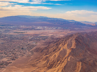 Fototapeta na wymiar Sunset aerial view of the Frenchman Mountain and cityscape of Las Vegas