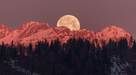 Full moon setting behind the mountains - Powered by Adobe