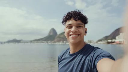 Fotobehang Latin young man, famous beach Rio de Janeiro, Brazil. Latin summer vacation holiday. © Brastock Images