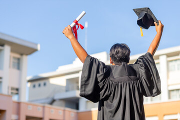 Graduates in gowns and graduation caps with diplomas