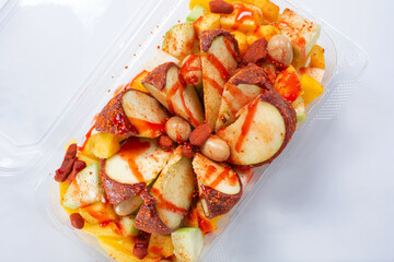 A top down view of a Mexican fruit bowl known as Manzana loca.