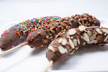 A view of chocolate covered frozen bananas.