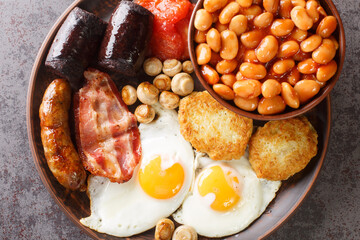 Traditional hot irish breakfast closeup in the plate on the table. Horizontal top view from above