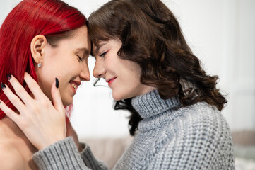 Obraz na płótnie Canvas Young Caucasian women hugging tenderly. Same-sex relationships.