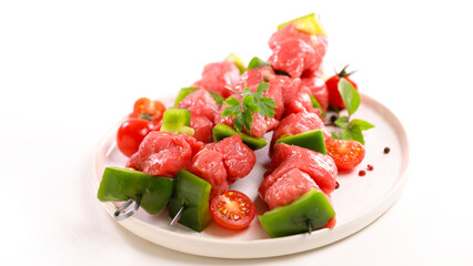 raw barbecue beef skewers on plate
