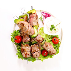 grilled beef skewer and lettuce isolated on white background