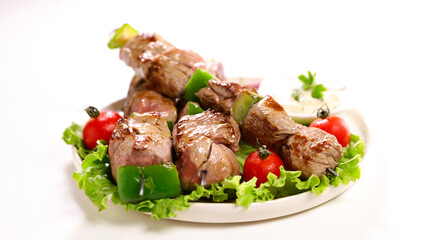 grilled beef skewer and lettuce isolated on white background