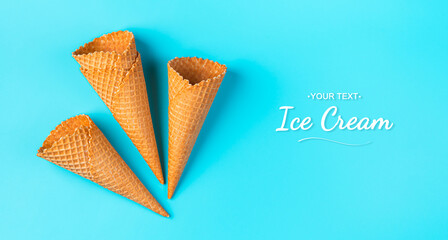 Empty waffle ice cream cups on a light blue background. Top view
