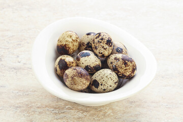 Raw quail eggs heap in the bowl