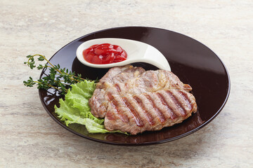 Grilled pork neck steak with ketchup