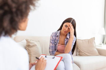 Woman at therapy session. Attentive psychologist. Attentive psychologist holding pencil in her...