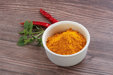 Yellow vibrant curcuma powder in the bowl