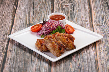 Grilled chicken wings served onion