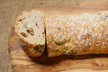 Fresh Mediterranean style bread with olives. Premium quality bakery product. Brown color background.