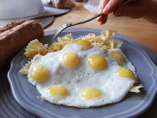 Fried eggs and pasta for breakfast