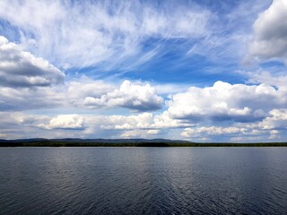 White clouds over a dark lake