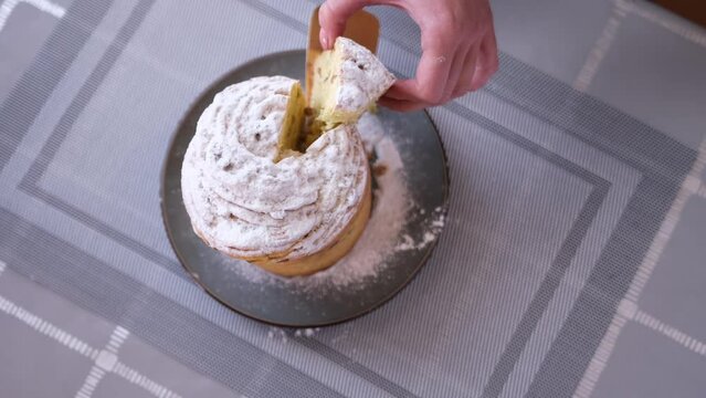 Woman taking piece of traditional Easter cruffin cake - Happy Easter concept