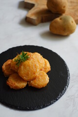 a plate of fried potato cake named perkedel kentang in Bahasa 