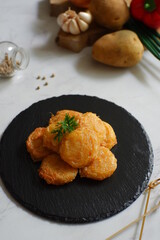 a plate of fried potato cake named perkedel kentang in Bahasa 