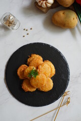 a plate of fried potato cake named perkedel kentang in Bahasa 