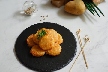 a plate of fried potato cake named perkedel kentang in Bahasa 
