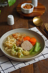 a plate of vegetables and meat soup 