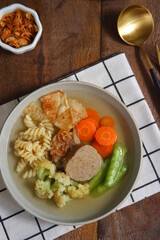 a plate of vegetables and meat soup 