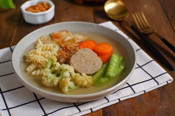 a plate of vegetables and meat soup 