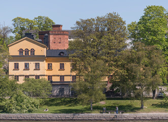 Fototapeta na wymiar Old caserne and water tower on the former military island Skeppsholmen a sunny day in Stockholm