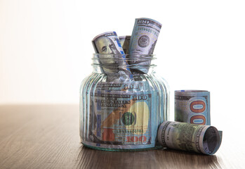 Glass jar with many of dollars money, Saving Conceptual