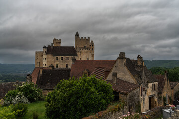 Fototapeta na wymiar view of the Beynac Castle in the Dordogne Valley under an overcast expressive sky
