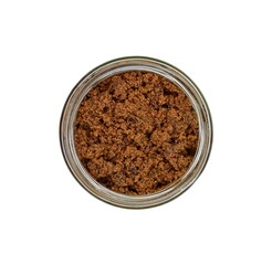 Raw Cane Sugar in a jar isolated on white background. Pile of dark brown soft sugar, isolated . Natural dark muscovado, top view.