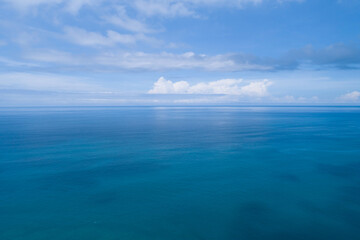 Aerial view of a blue sea surface water texture background and sun reflections Aerial flying drone view Waves water surface texture on sunny tropical ocean in Phuket island Thailand