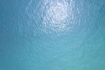 Naklejka na ściany i meble Sea surface background aerial view,Bird eye view photo of small waves and water surface texture Turquoise sea background Beautiful nature Amazing view