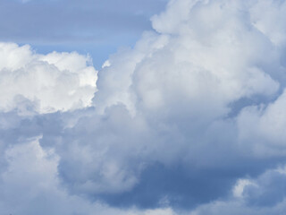 Naklejka na ściany i meble Cumulus clouds. White clouds on the blue sky close-up.