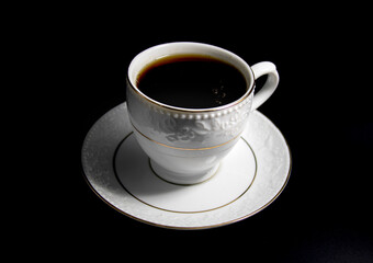 Porcelain cup of tea with tea isolated on black background