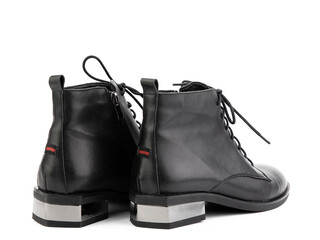 Women's autumn black leather jodhpur boots with black sole isolated on white background. Back side view. Fashion shoes. Photoshoot for shoe shop