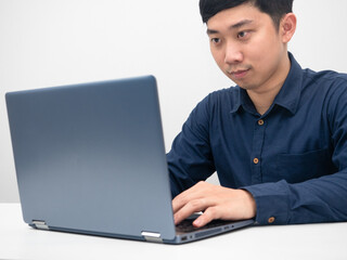 Man sitting at office workplace using laptop for working